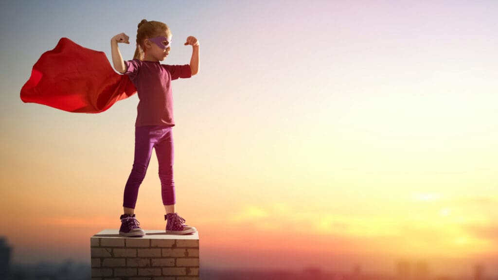 young girl with superhero cape, sunrise in the background