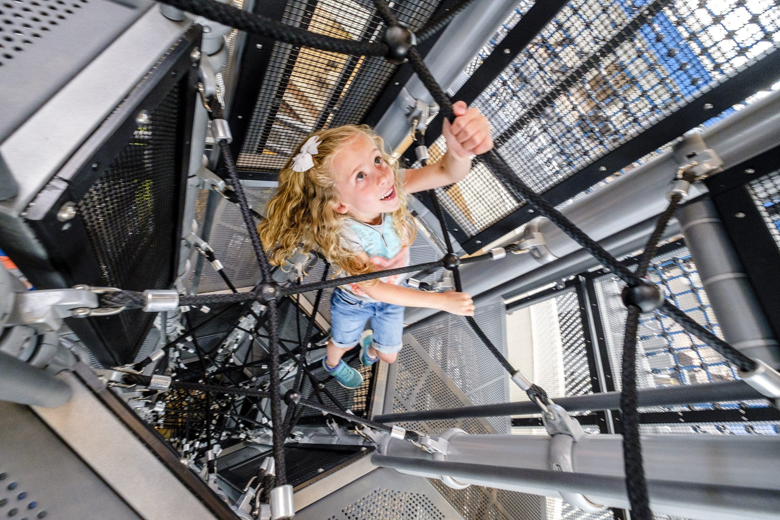 Girl climbing jungle gym
