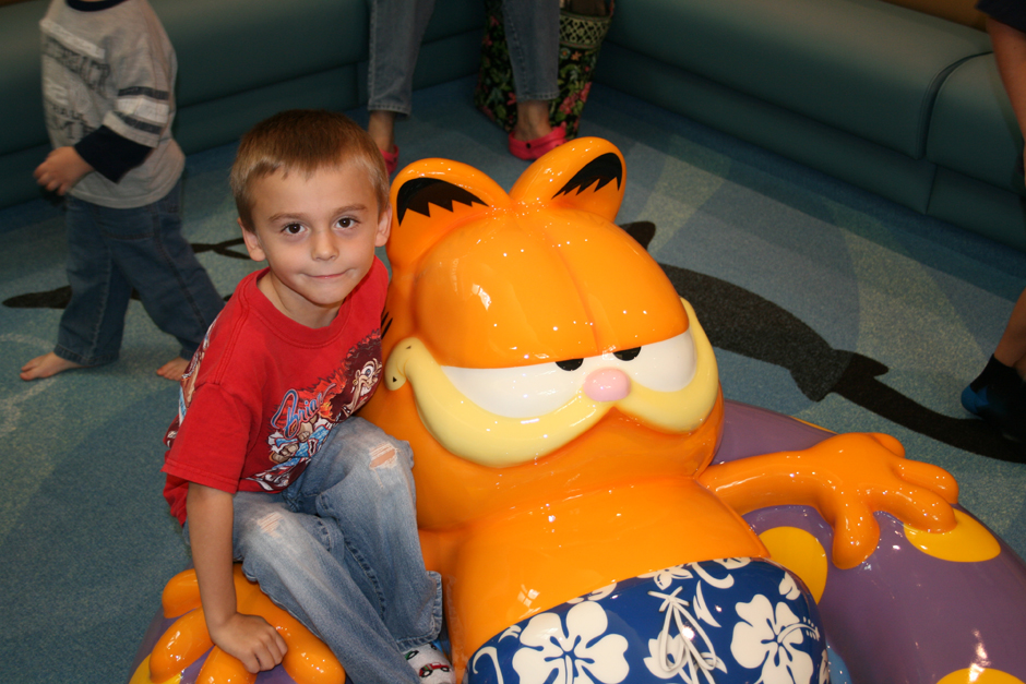 Child sitting on Garfield Soft Play sculpture