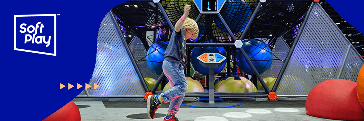 A child happily plays at an indoor playground
