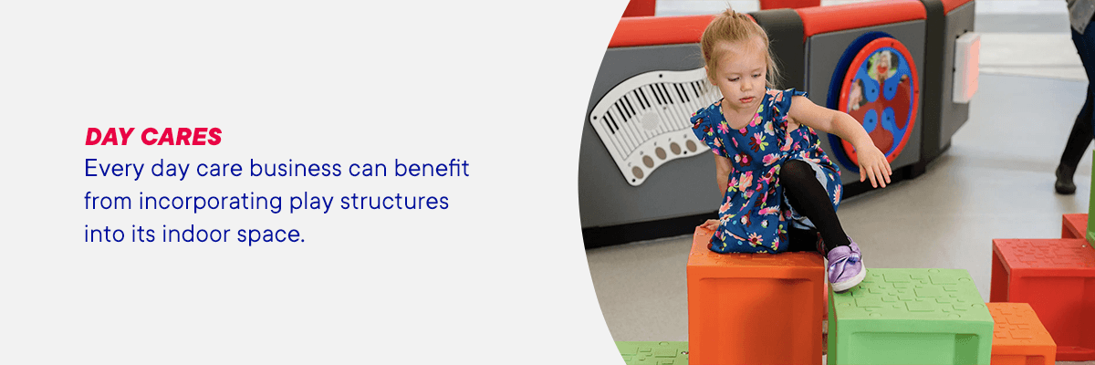 A young girl plays on indoor playground equipment at daycare