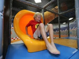 kid coming out of curved slide