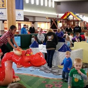 parents and kids using play area at mall