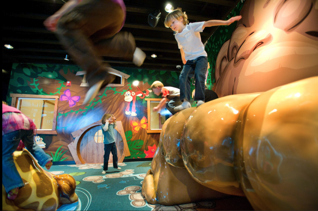 children climbing and jumping on soft sculpture playground