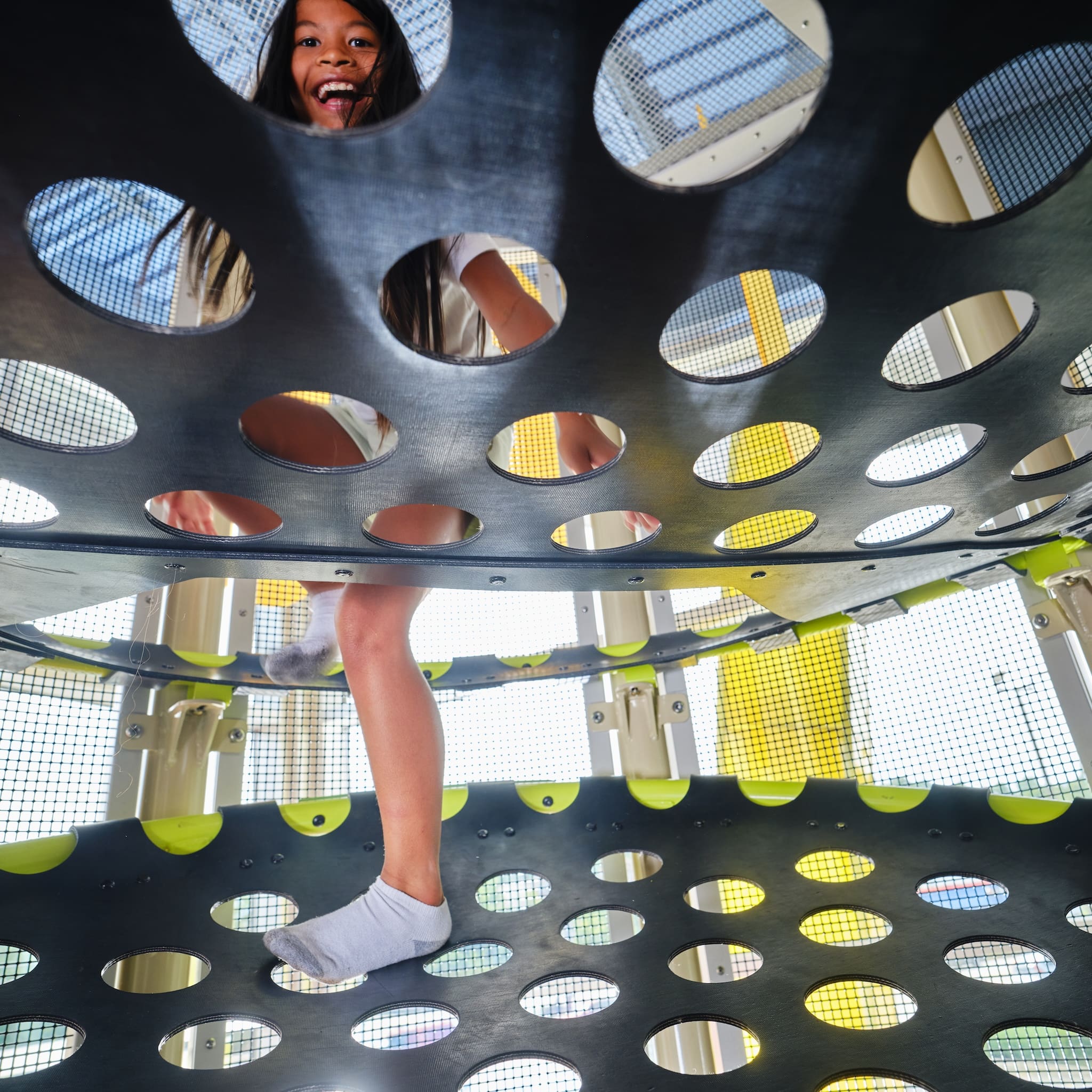 indoor playground, climbing tower, girl climbing up the platforms
