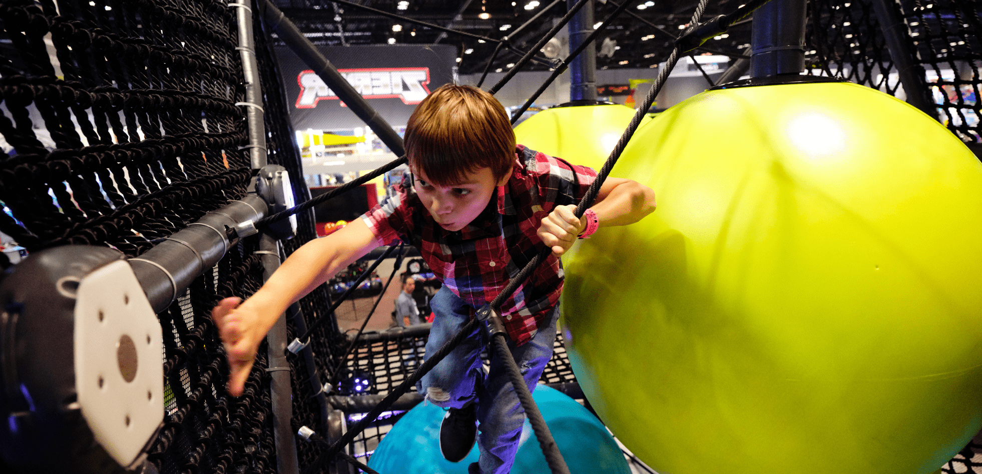young man hitting the game score button in the HIVE playground